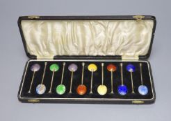 A cased set of twelve George V silver and polychrome enamel coffee spoons (enamel a.f.).
