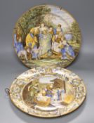 Two Italian Urbano style chargers ‘The Finding of Moses’ and figures by a fire, 37 cms diameter.