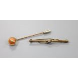 A gilt metal stick pin set with yellow metal serpent entwined coral bead, 60mm and a 9ct, sapphire