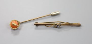 A gilt metal stick pin set with yellow metal serpent entwined coral bead, 60mm and a 9ct, sapphire