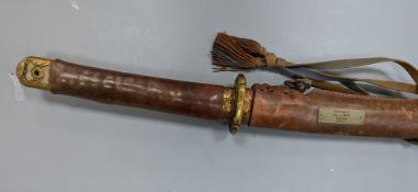 A Japanese Katana with leather covered sheath, plaque reading ‘Presented to Capt. S. Mear Telecoms