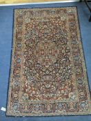 A Kashan blue ground rug, 185x122cm.