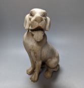 A carved wood model of a seated dog 29cm