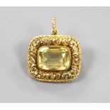 A Victorian foliate embossed yellow metal and citrine set mourning pendant brooch, with glazed back,