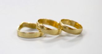 Two 9ct gold wedding bands, 4.7 grams and one other shaped yellow metal band, 3.3 grams.