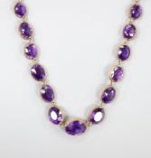 A late Victorian yellow metal and graduated oval cut amethyst set necklace, 39cm, gross weight 37