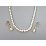 A single strand and graduated cultured pearl necklace, with marcasite set clasp, 44cm and a pair