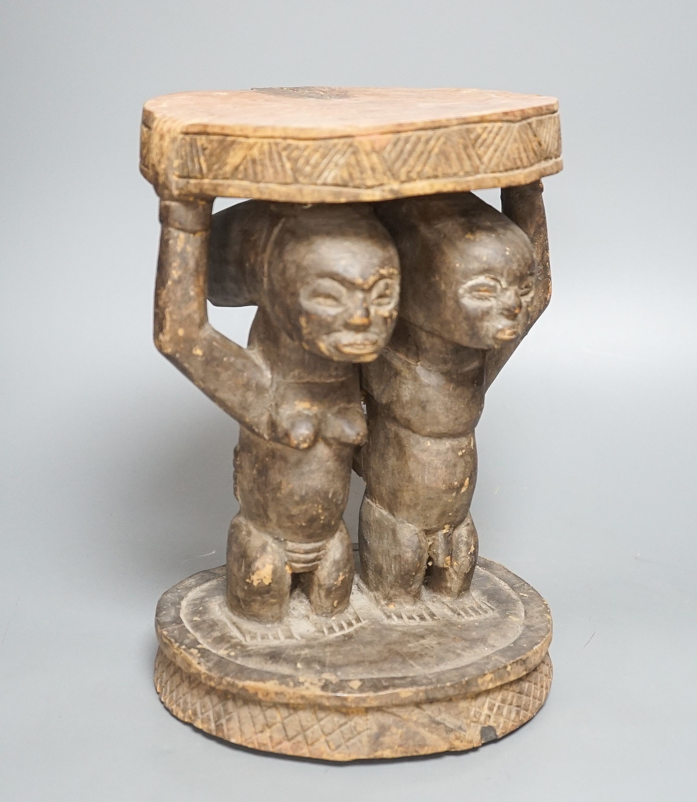 A Yoruba carved wood stool, modelled with male and female figures 27cm - Image 2 of 5