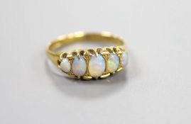 An 18ct gold and graduated oval white opal set half hoop ring, size Q/R, gross weight 3.4 grams.
