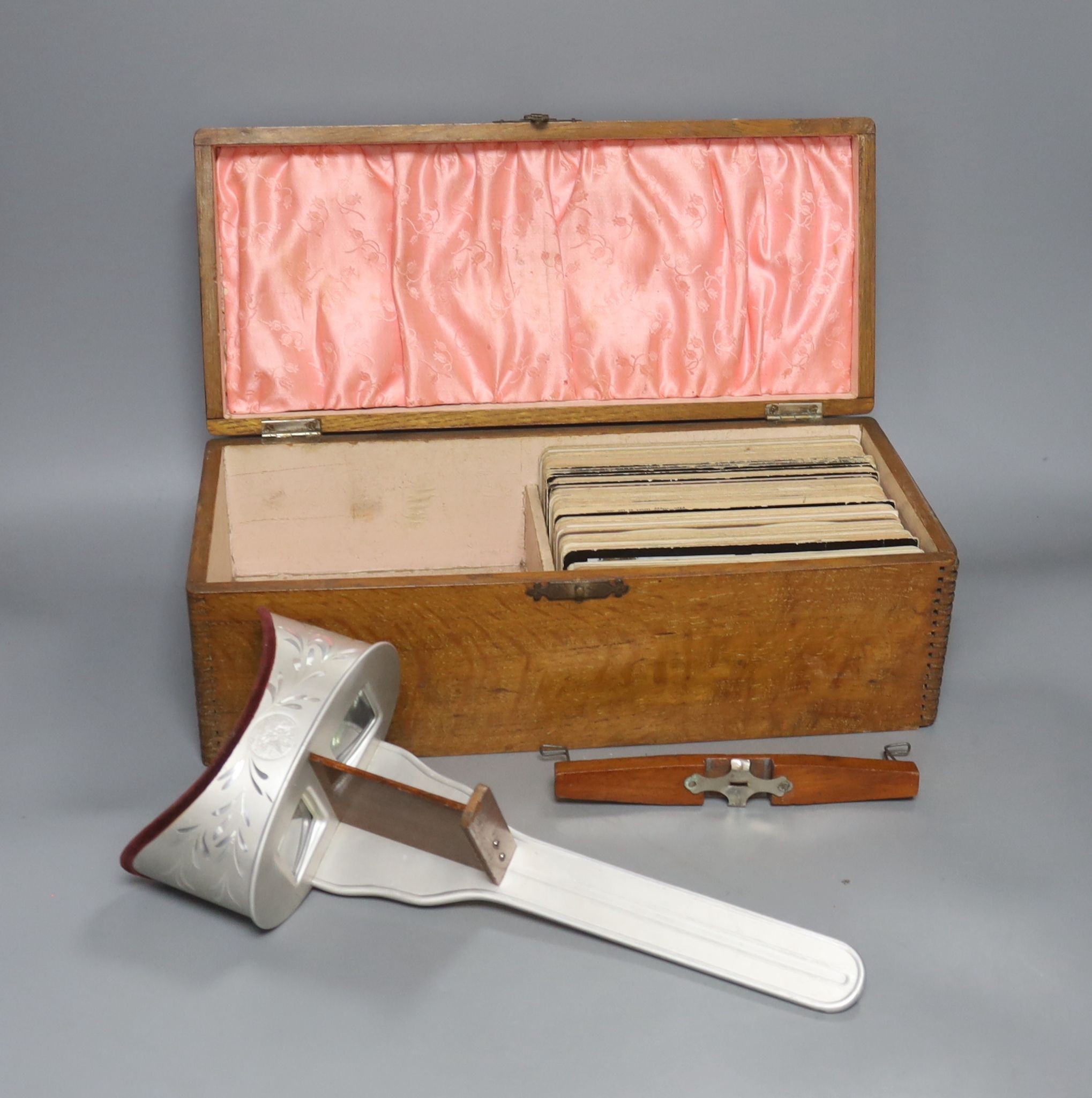 A boxed stereoscopic viewer and collection of cards,viewer 32 cms long.