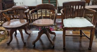 Two early 20th century swivel desk chairs and another chair.