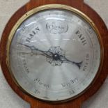 A mahogany wheel barometer. Length -107cm, W-32cm.