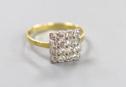 An 18ct and sixteen stone diamond set cluster tablet ring, size O, gross 2.5 grams.