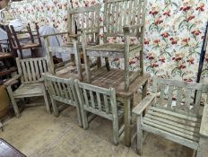 A weathered teak rectangular garden table and six elbow garden chairs, not matching. Table measures,