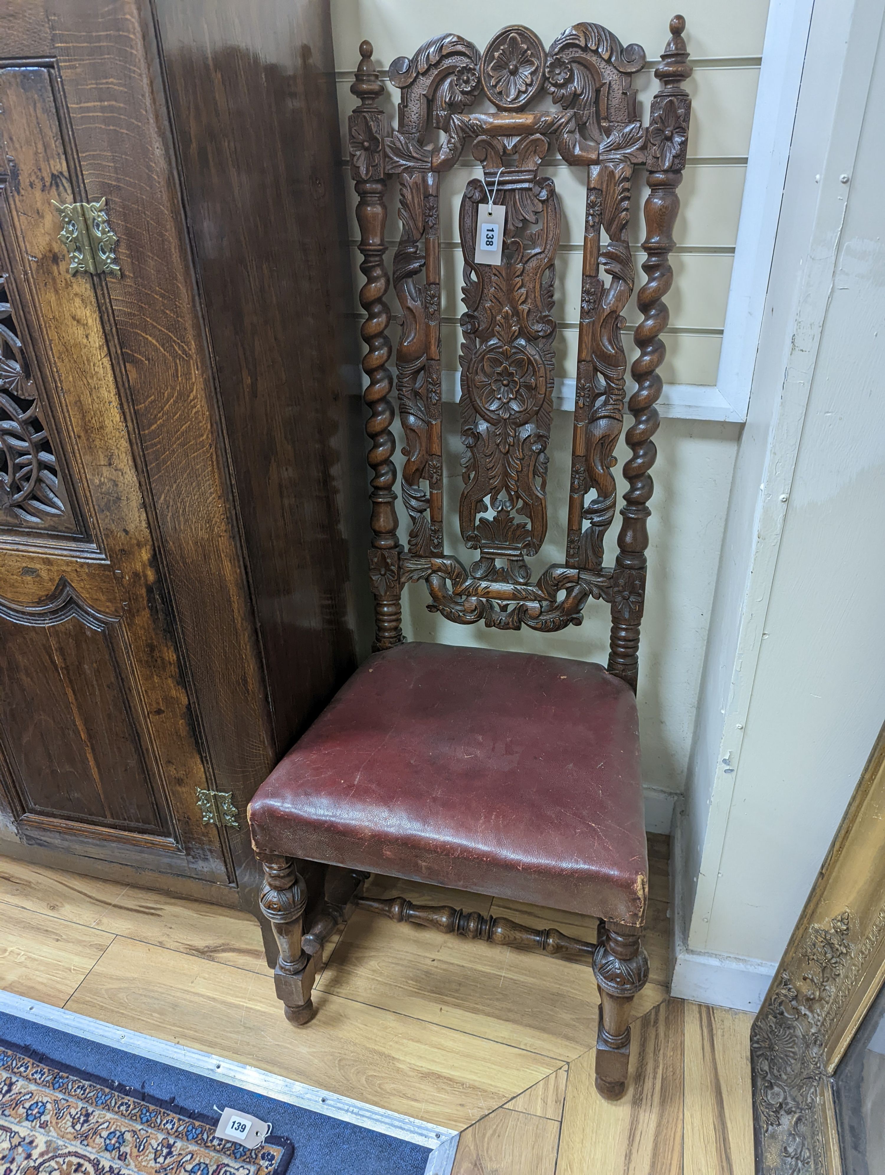 A Carolean design oak high back dining chair. H-128cm.