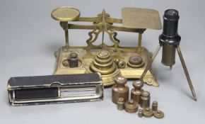 An Otis King's pocket calculator, a Voigtlander scope and brass postal scales