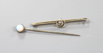 A yellow metal and solitaire diamond set bar brooch, 50mm and a single stone opal set stick pin.