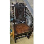 A 17th century oak dining chair, with carved panelled back, solid seat and barley twist