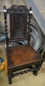A 17th century oak dining chair, with carved panelled back, solid seat and barley twist