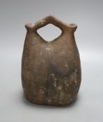 An Egyptian pottery flask, 23 cms high