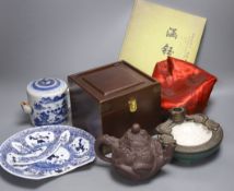 A Chinese Yixing teapot, similar blue and white teapot, blue and white dish and a candle holder,