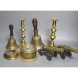 A quantity of brassware including bells, model cannons, candlesticks etc.