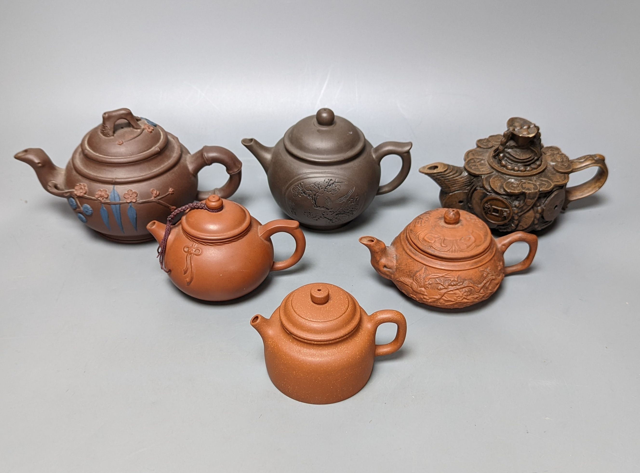 A Chinese stoneware 'cash' teapot and cover and five Yixing teapots (6)