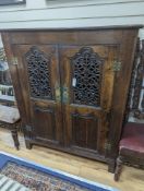 An 18th century and later French carved oak side cabinet. W-112cm, D-46cm, H-136cm.