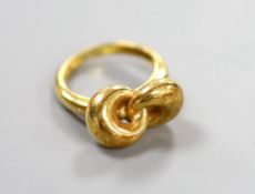 A 750 yellow metal 'knot' ring, size L, 6.4 grams.