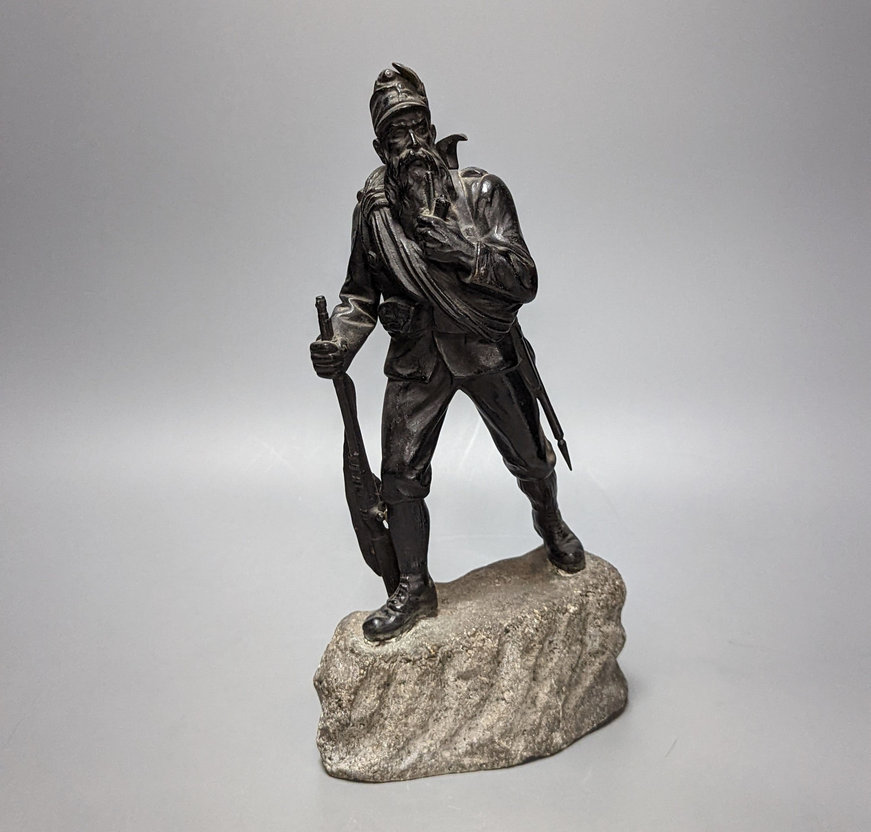 A WW1 period bronze figure of an Austrian soldier, 30 cms high including stone base.