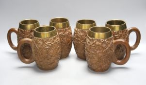 A set of six South Asian carved teak mugs 15.5cm