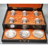 A cased Japanese white metal and eggshell porcelain six piece coffee set, maker’s mark only, case