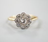 An 18ct, Pt and diamond set flower head cluster ring, size N, gross weight 2.4 grams.