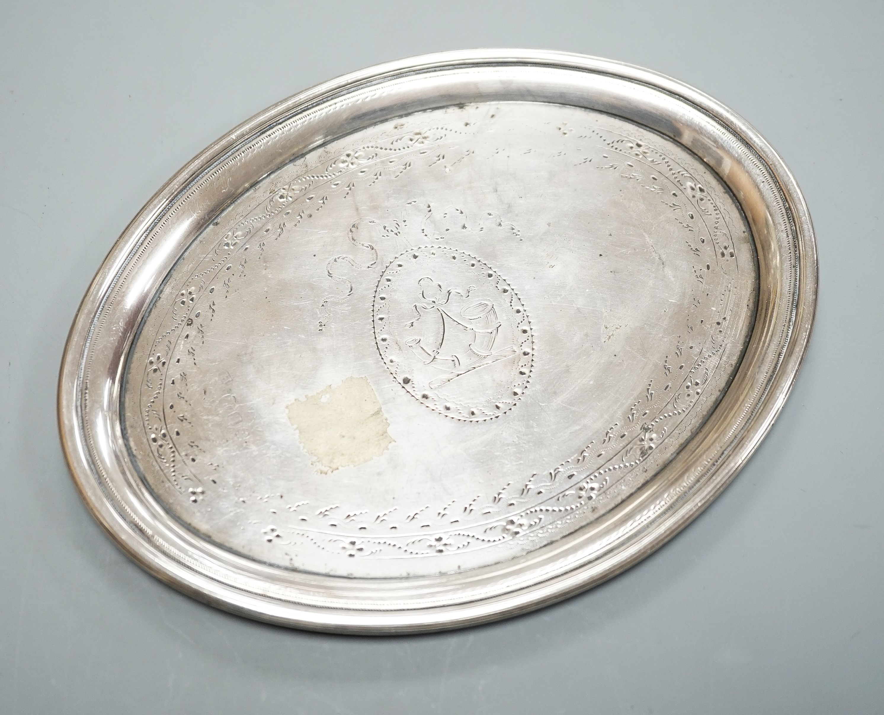 A George III silver oval teapot stand, with tired engraved decoration and wooden base, London, 1790,