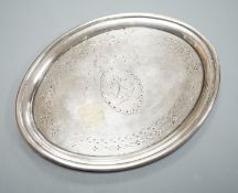 A George III silver oval teapot stand, with tired engraved decoration and wooden base, London, 1790,