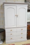 A Victorian later painted pine linen press, with two doors enclosing sliding trays, width 130cm,