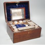 Two Victorian rosewood cased travelling vanity sets with silver plated covers (2)