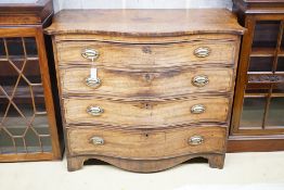 A George III mahogany serpentine chest with ebony stringing and four graduated long drawers, the top