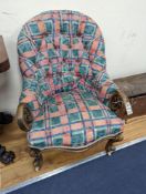 A Victorian carved walnut button back armchair