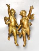 A pair of gilt metal cherub hanging figures, 26cm