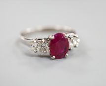 A modern 750 white metal single stone ruby and four stone princess cut diamond set half hoop ring,