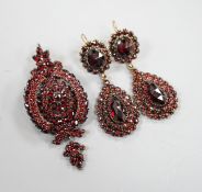 A pair of Victorian gilt metal and facet cut garnet set drop earrings, 51mm and a similar white