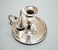 A George III silver chamberstick, by John Arnell, with beaded border and matching sconce and