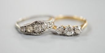 An 18ct and three stone diamond ring, size M and a white metal and graduated five stone diamond