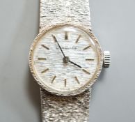 A lady's textured 9ct white gold Longines manual wind wrist watch, case diameter 19mm, overall