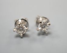 A pair of 750 white metal and solitaire diamond set ear studs, the stones measuring 3.5mm in