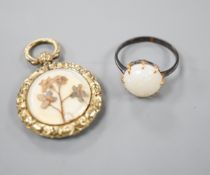 A yellow metal and white opal ring, size K/L and a late Victorian engraved yellow metal pendant,