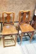 A pair of mahogany hall chairs, (one cut down)