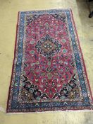 A Najaf Abad claret ground rug, 200 x 114cm