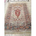 An antique Turkish? ivory ground rug, 218 cm long, 145 cm wide